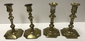 Two pairs of 18th Century brass candlesticks of typical form,