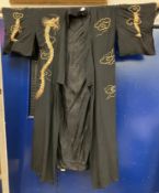 A mid 20th Century silk kimono with couched embroidered dragon and cloud decoration