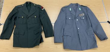 A USAF jacket dated 1957 with buttons, a German border guard uniform jacket,