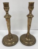 A pair of 18th Century bell metal candlesticks on ornate petal bases, 27 cm high,