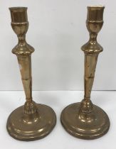 A pair of 18th Century bell metal candlesticks on ornate petal bases, 27 cm high,