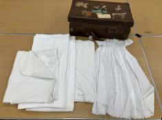 A vintage brown suitcase bearing various label remains containing a small collection of cotton