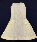 A 1920s silk and broderie anglaise cream under dress, the plain top and skirt, divided by large,