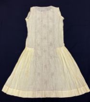 A 1920s silk and broderie anglaise cream under dress, the plain top and skirt, divided by large,