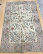A pair of early 20th Century crewelwork panels with floral decoration on cream and pink grounds,