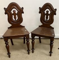 A pair of Victorian mahogany panel seated shield back hall chairs on baluster turned front legs 42.