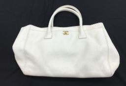 A Chanel Cerf bag in white grain calves leather with gold coloured hardware and authenticity card