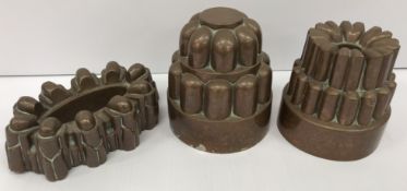 A collection of three 19th Century copper jelly moulds, one maked with cross and orb and No'd.