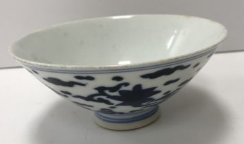 A Ming style Chinese blue and white saucer bowl, the main body decorated with bats amongst clouds,