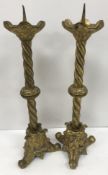 A pair of gilt brass pricket candlesticks in the Gothic Revival taste 55 cm high