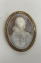 An 18crt gold mounted cameo brooch depicting a young woman with flowing hair,