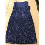 A sleeveless cocktail dress by Caroline Charles Studio in midnight blue sequined fabric,