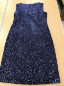 A sleeveless cocktail dress by Caroline Charles Studio in midnight blue sequined fabric,