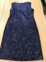 A sleeveless cocktail dress by Caroline Charles Studio in midnight blue sequined fabric,