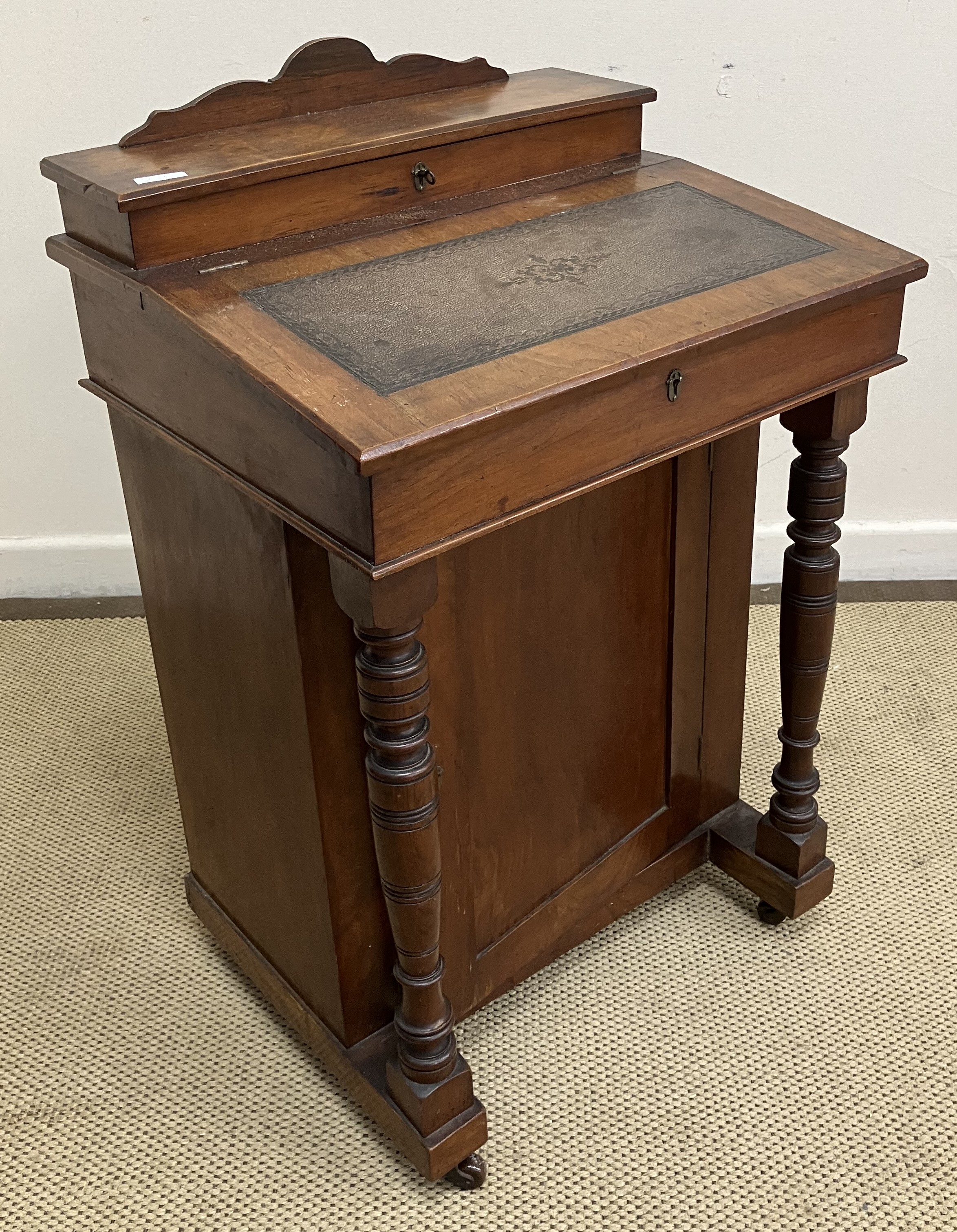 A late Victorian walnut Davenport desk of small proportions, 53 cm wide x 80 cm high,