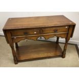 A modern oak two drawer side table in the 18th Century manner,