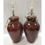 A pair of 20th Century Chinese style sang de boeuf table lamps of vase form 44 cm high not