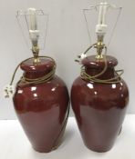 A pair of 20th Century Chinese style sang de boeuf table lamps of vase form 44 cm high not