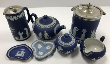 A collection of Wedgwood blue Jasper ware with Classical relief decoration including a cylindrical