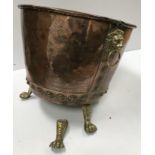 A Victorian copper copper of typical form now with lion mask ring handles and brass paw feet as a