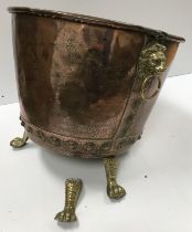 A Victorian copper copper of typical form now with lion mask ring handles and brass paw feet as a