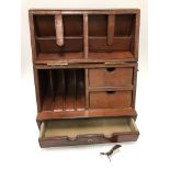 A modern leather covered desk tidy opening as a slope top cabinet with various pigeonholes and