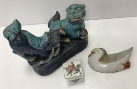 A Japanese pottery figure group depicting two dogs of Fo in blue and turquoise glaze 11 cm high