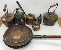A collection of various copper ware to include a Jersey measure, wooden handled warming pan,