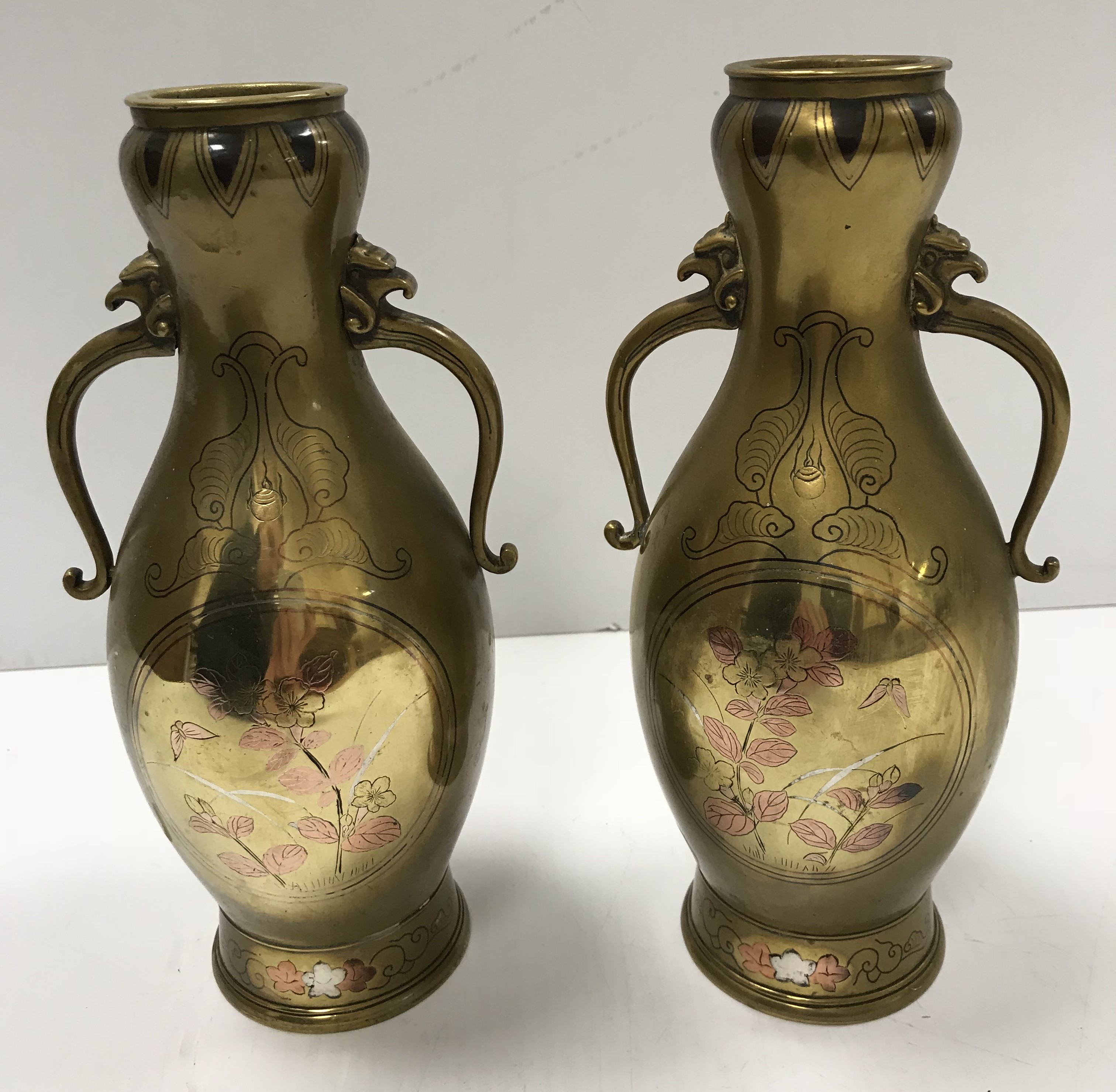 A pair of Chinese brass baluster shaped vases with stylised beast head handles,