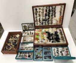 A large box of various modern fishing flies,