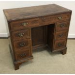 A burr walnut veneered kneehole desk in the early 18th Century manner,