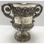 A George IV silver wine cooler with twin handles and oak leaf and acorn decorated band to the top,