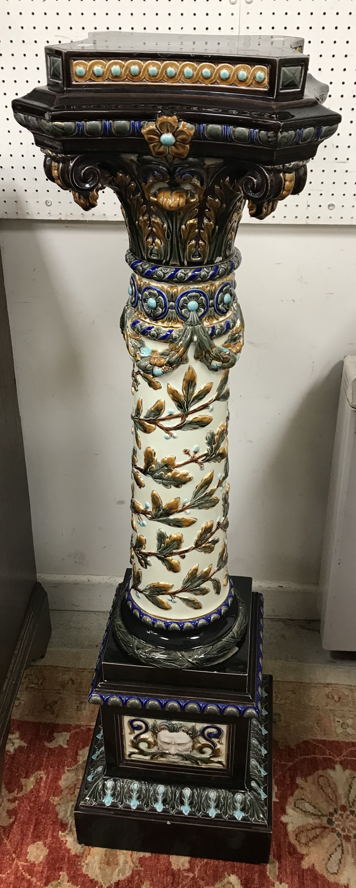 A circa 1900 Swedish majolica urn stand by Rörstand with all over relief work decoration on a