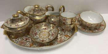 An early 19th Century Spode type gilt and polychrome decorated duet tea service comprising tray,