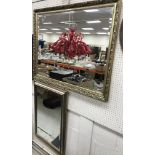 A modern gilt framed rectangular wall mirror with bevelled edge,