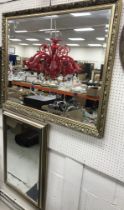A modern gilt framed rectangular wall mirror with bevelled edge,