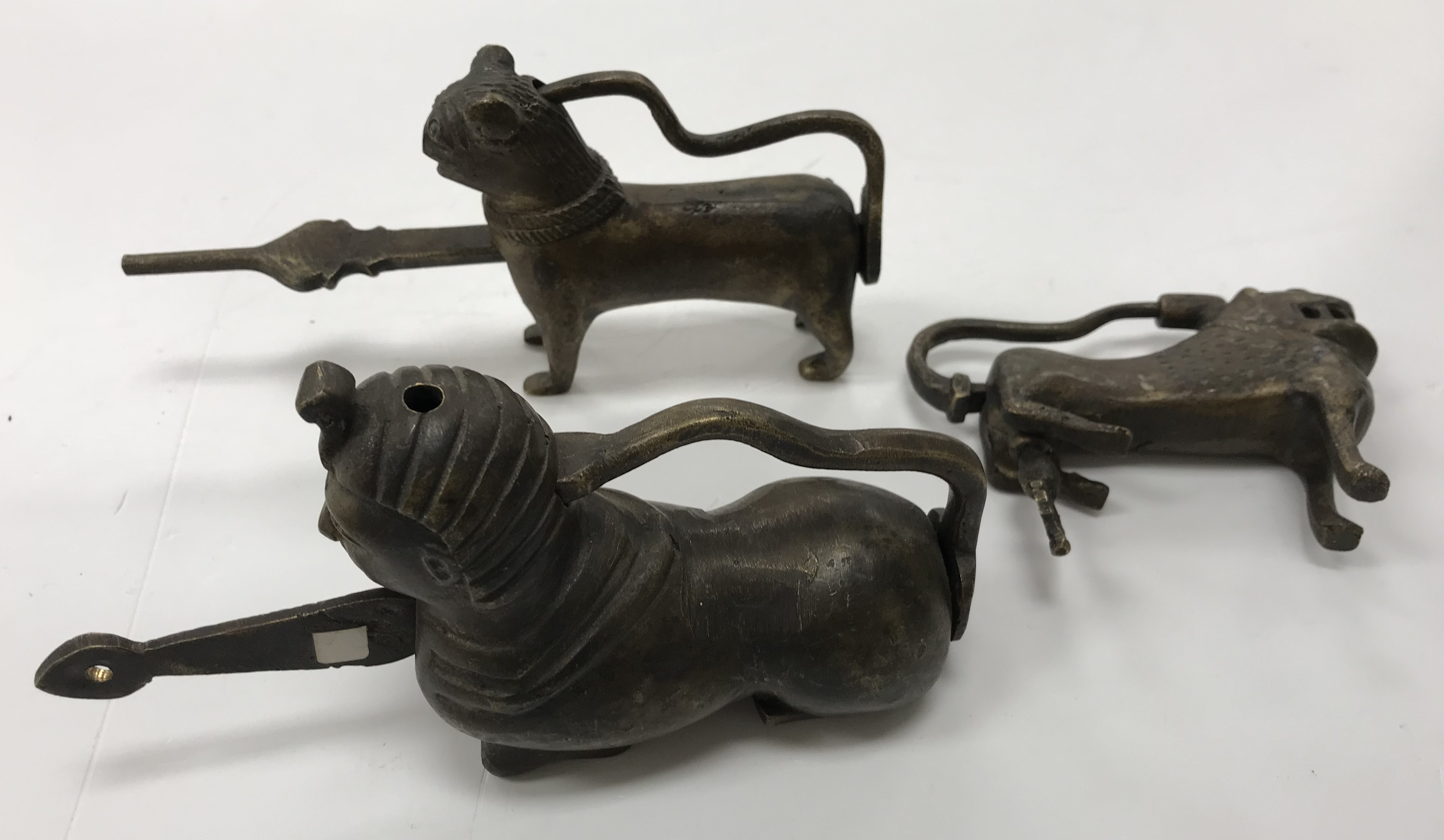 A brass lock or padlock of Sphinx form, 12 cm long, a brass lock of lion form, 10 cm long,