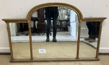 An 18th Century carved giltwood and gesso framed overmantel mirror with lotus leaf carved domed top