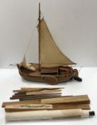 A collection of items to include a model Thames barge, a small African canoe model,