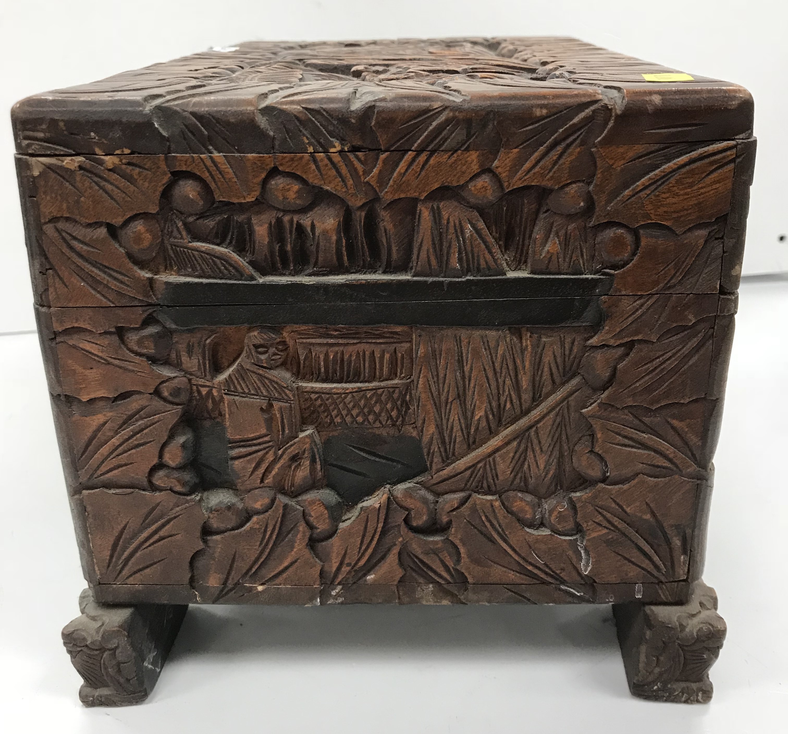 An Indonesian carved camphor wood miniature trunk with all over figural and foliate decoration - Image 7 of 8