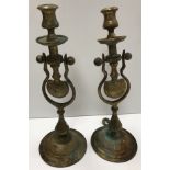 A pair of brass ship's type gimble candlesticks with mounting loops on a circular foot 38 cm high