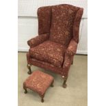 A modern "Shelley" wing back scroll arm chair on carved cabriole legs to claw and ball feet,