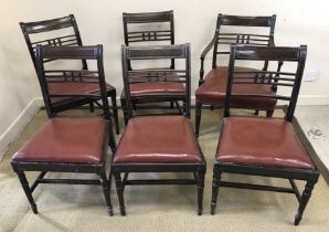 A set of five Victorian mahogany bar back dining chairs with drop in seats on turned legs united by