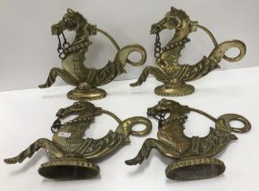 A collection of four Venetian brass hippocamp gondola ornaments on oval bases 28.