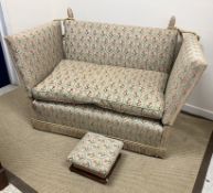 An upholstered Knole two seat sofa with all-over tulip lattice work design,