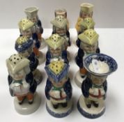 A collection of eight 19th Century Staffordshire pottery Toby peppers, a similar salt,