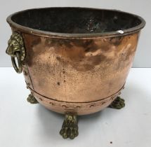 A Victorian copper copper of typical form now with lion mask ring handles and brass paw feet as a