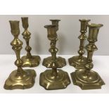Two pairs of 18th Century brass candlesticks of typical form,