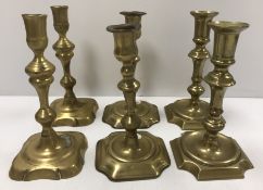 Two pairs of 18th Century brass candlesticks of typical form,