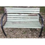 Two wooden garden benches, one painted green 122 cm wide ,